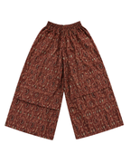 A pair of wide-leg cropped pants featuring an all-over brown and red paisley pattern, displayed flat against a solid white background.