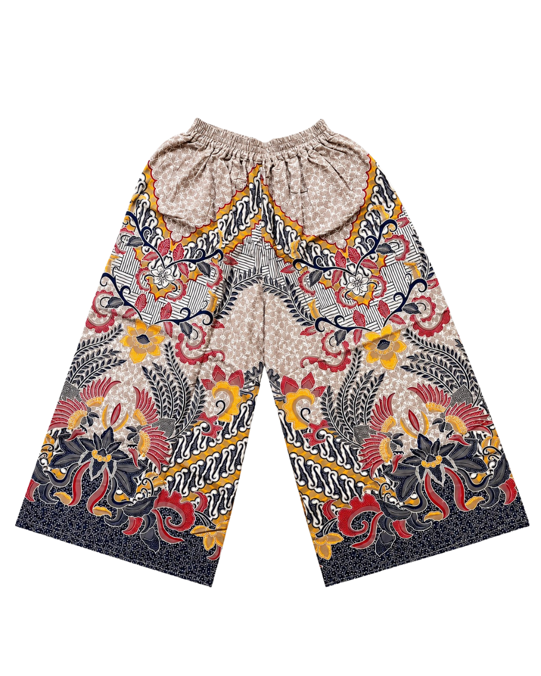 A pair of wide-leg pants featuring a complex batik-style pattern with red, yellow, black, and beige motifs, laid flat against a white background.
