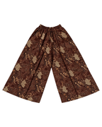 A pair of wide-leg pants featuring a brown and beige batik-style pattern with geometric and floral motifs, displayed flat against a solid white background.