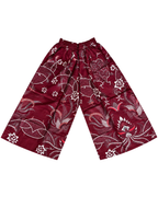 A pair of wide-leg, cropped pants in deep burgundy with a white and silver-toned floral and vine pattern, laid flat against a white background.