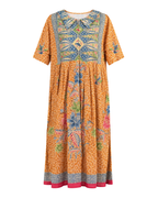 A short-sleeved midi dress with a vibrant orange base, featuring a detailed multicolor floral and geometric print, a Peter Pan collar, and a pink hem, shown against a plain white background.