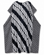 A loose, short-sleeved tunic dress with a bold black and white patterned design, featuring diagonal wavy stripes on the front and geometric diamond patterns on the sides, shown against a plain white background.