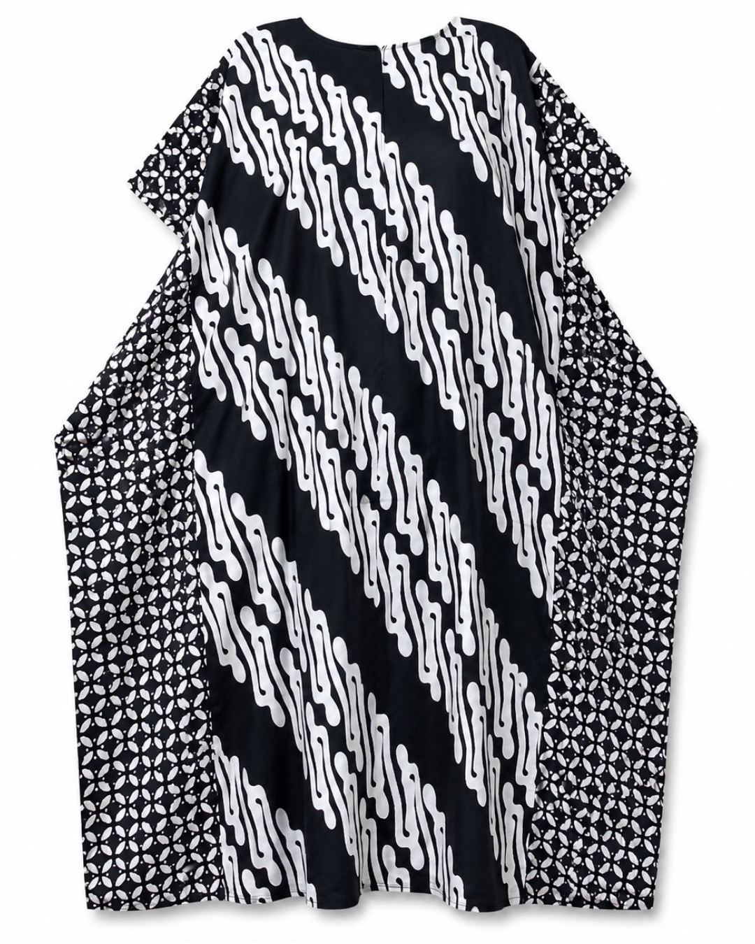 A loose, short-sleeved tunic dress with a bold black and white patterned design, featuring diagonal wavy stripes on the front and geometric diamond patterns on the sides, shown against a plain white background.