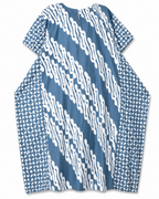 A loose-fitting short-sleeve tunic top with a blue and white patterned design, featuring diagonal wavy stripes on the front and geometric prints on the sleeves, shown against a plain white background.