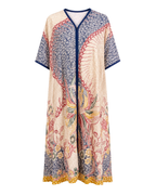 A long kaftan dress with a cream base and a multicolor floral and bird pattern, featuring a navy blue V-neckline and sleeve cuffs, shown against a plain white background.