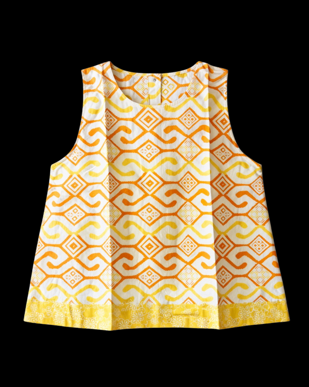 Yellow and white patterned sleeveless top on a black background
