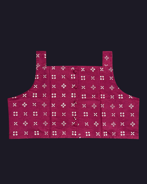 Red apron with white floral pattern on a black background