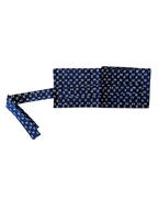 A navy blue fabric belt with a white geometric pattern, shown folded with one end extending to the left on a plain white background.