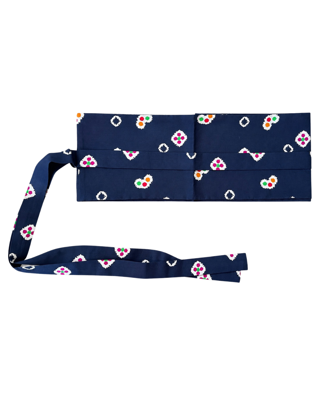 A navy blue fabric belt with a repeating ikat pattern in white, pink, green, and orange, displayed flat against a white background.
