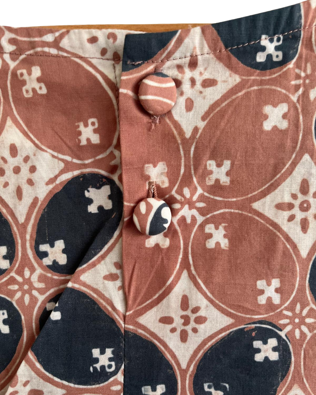 Close-up of a patterned fabric with circular and geometric designs.
